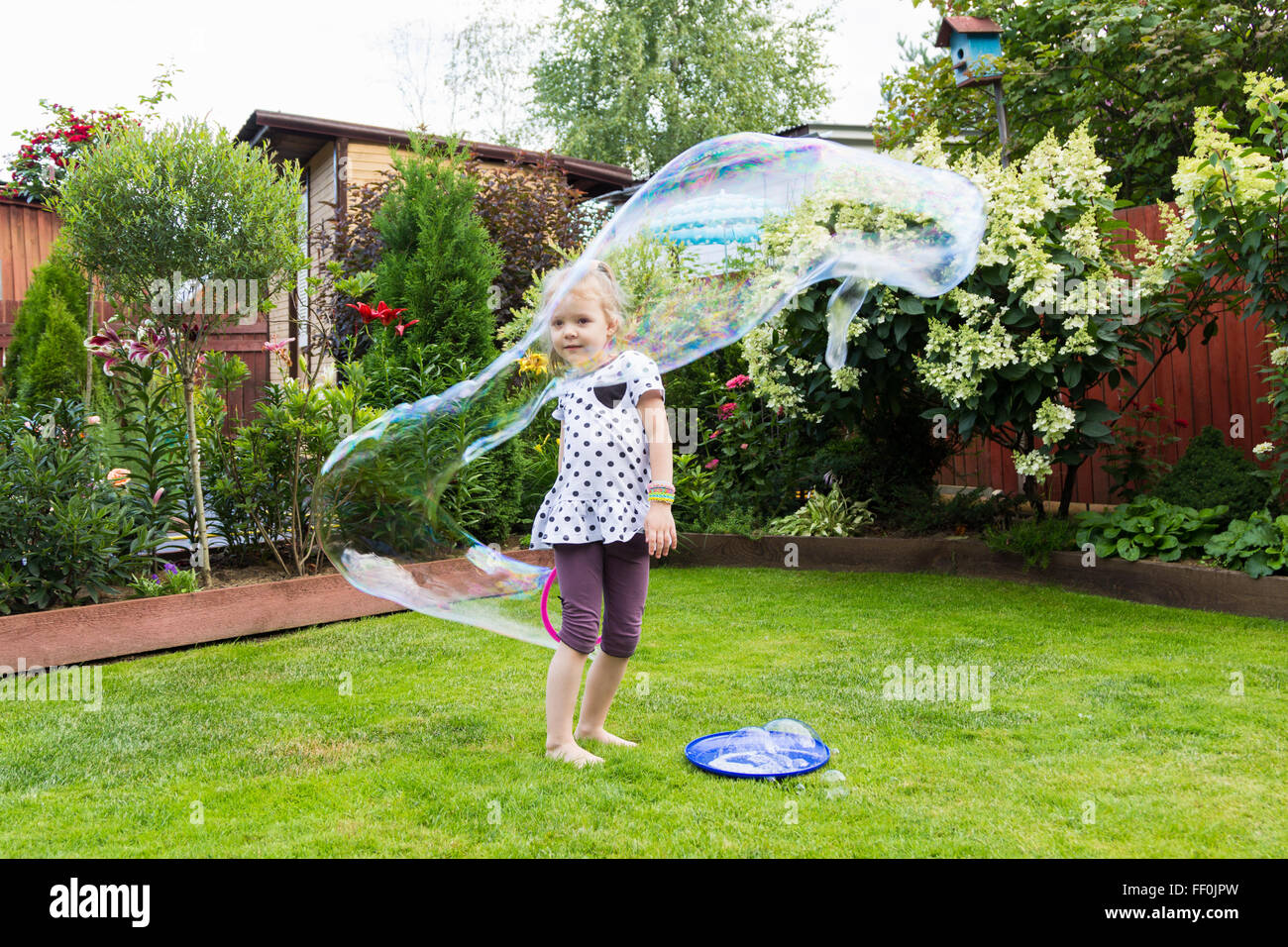 girl playing with soap bubbles in a beautiful garden Stock Photo - Alamy