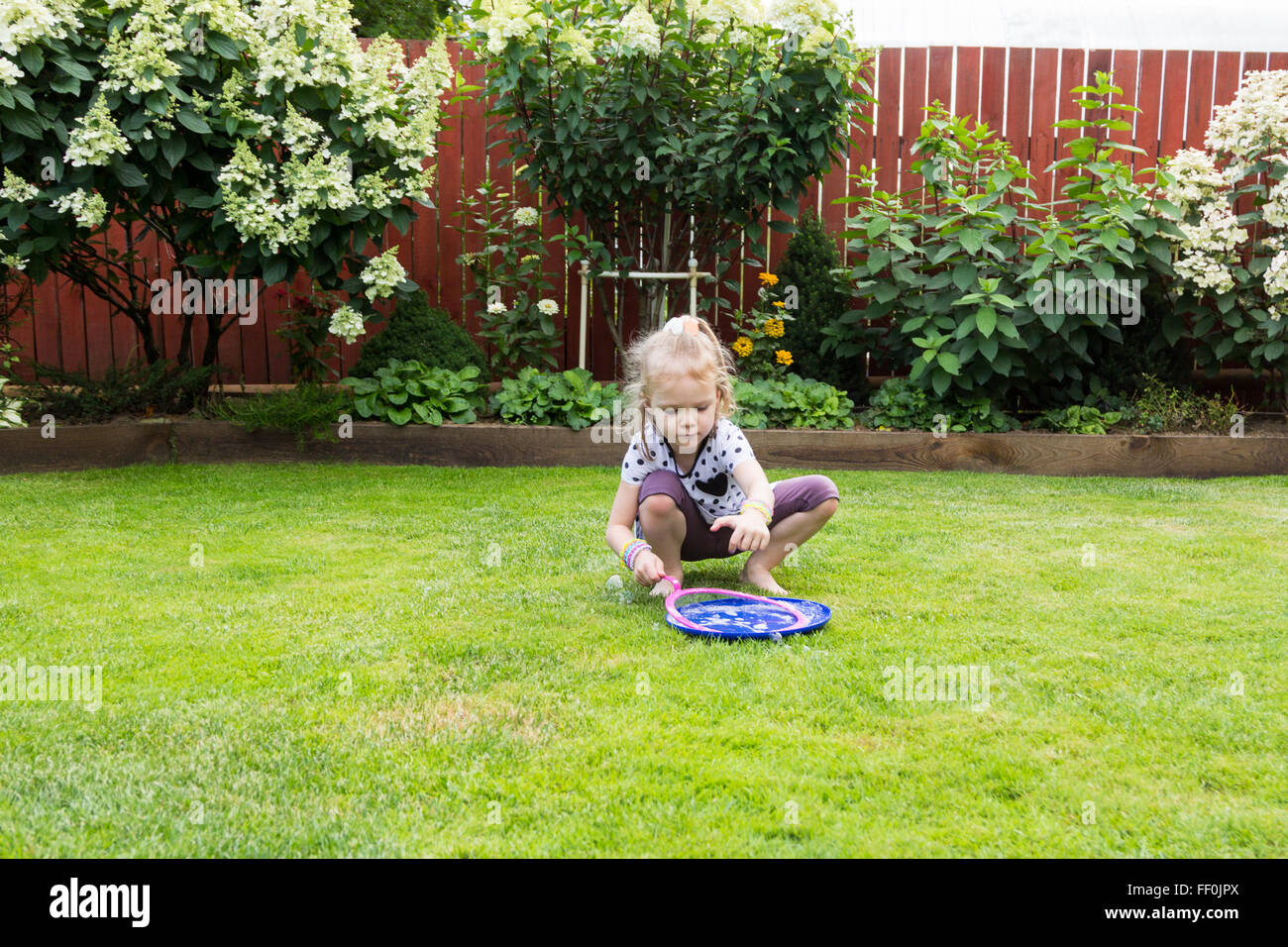 girl playing with soap bubbles in a beautiful garden Stock Photo - Alamy