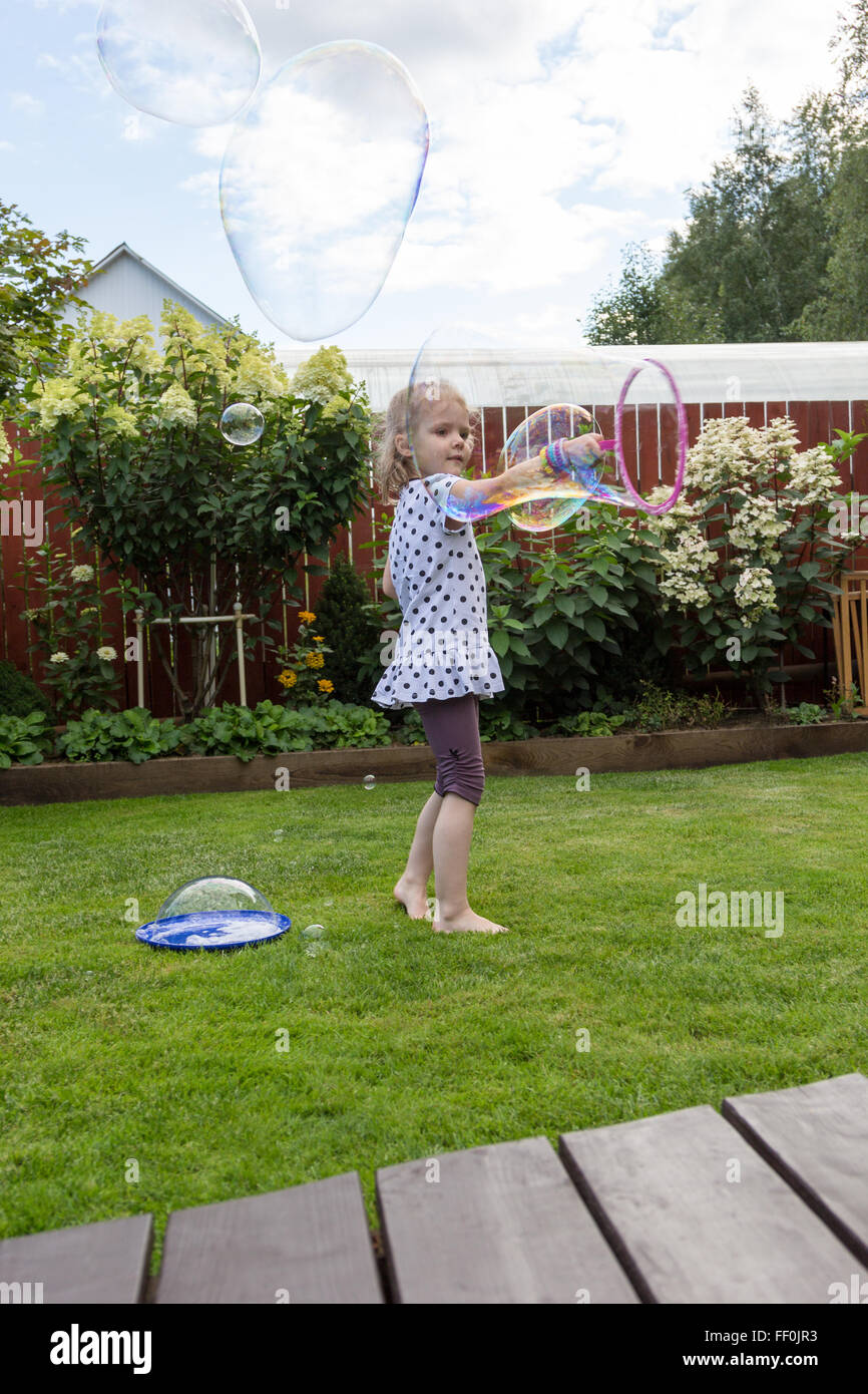 girl playing with soap bubbles in a beautiful garden Stock Photo - Alamy