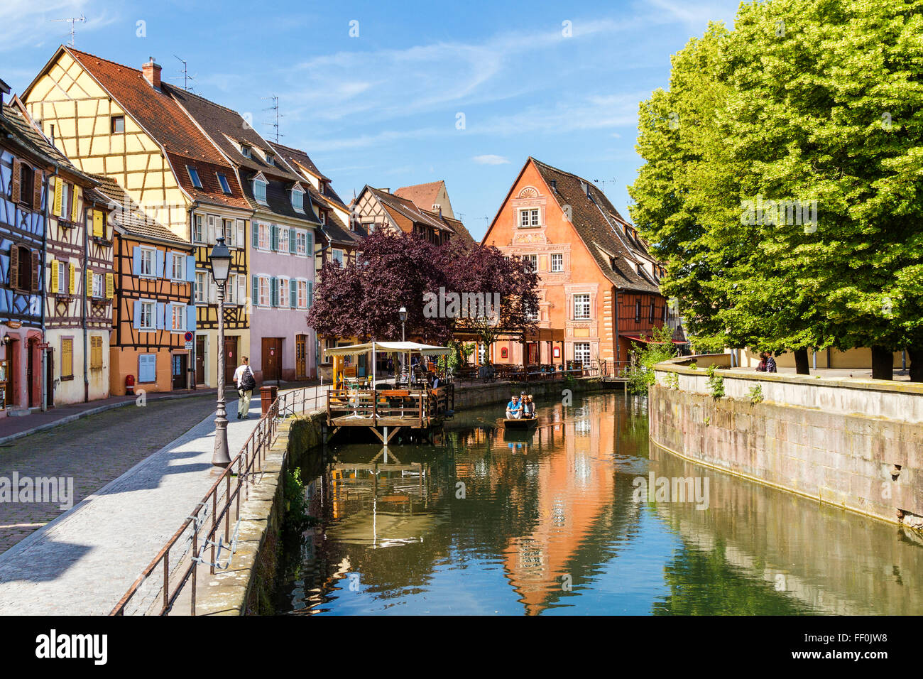 Tourists in a little tour boat along the Lauch river in La Petite Venise or Little Venice, district, Old Town, Colmar, Alsace, Stock Photo