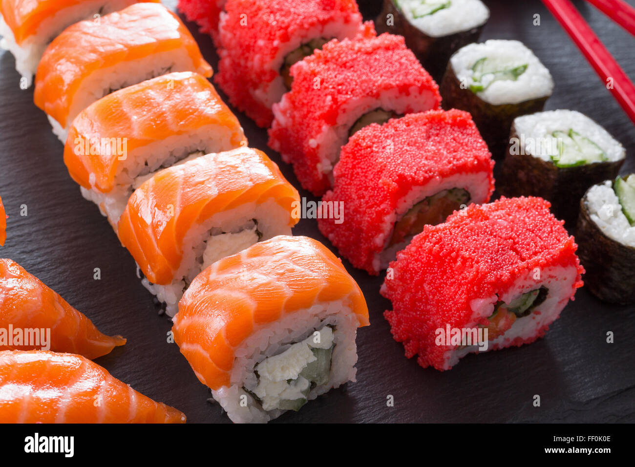 set of sushi and rolls on a slate table. Stock Photo