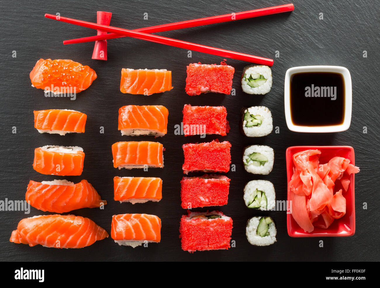 set of suchi and rolls on a slate table. Stock Photo