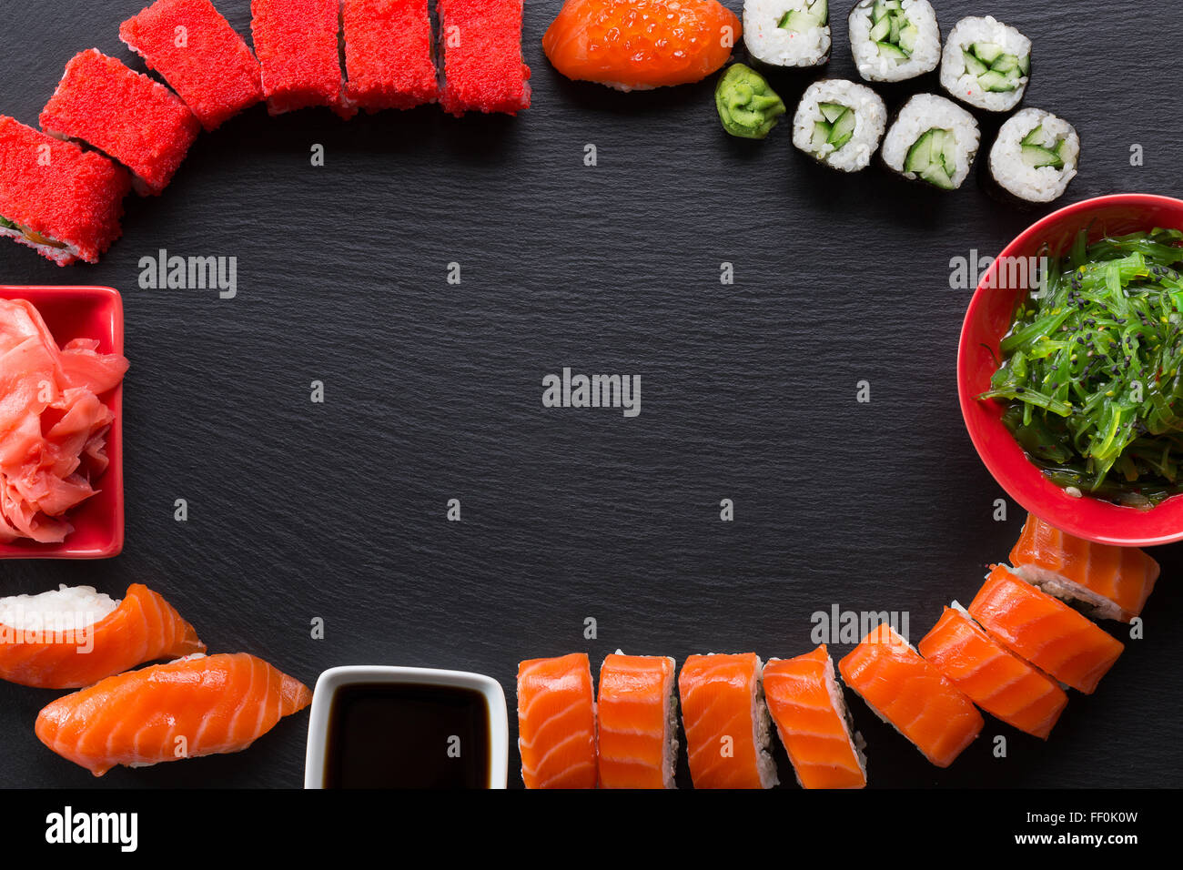 set of sushi and rolls on a slate table. Stock Photo