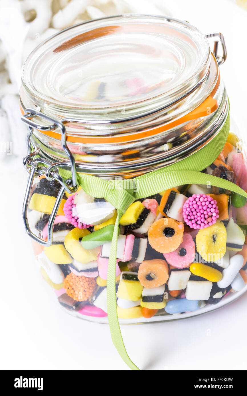 Candies in candy jar on a white background Stock Photo - Alamy