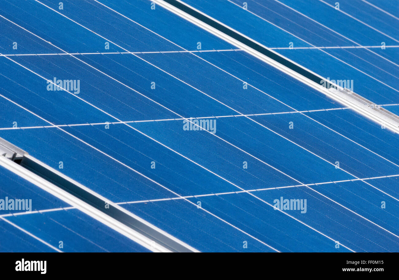 Close-up pattern of rectangular solar panels lying at angle. Stock Photo