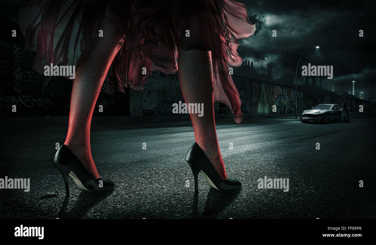 Woman wearing high heels on street at night Stock Photo