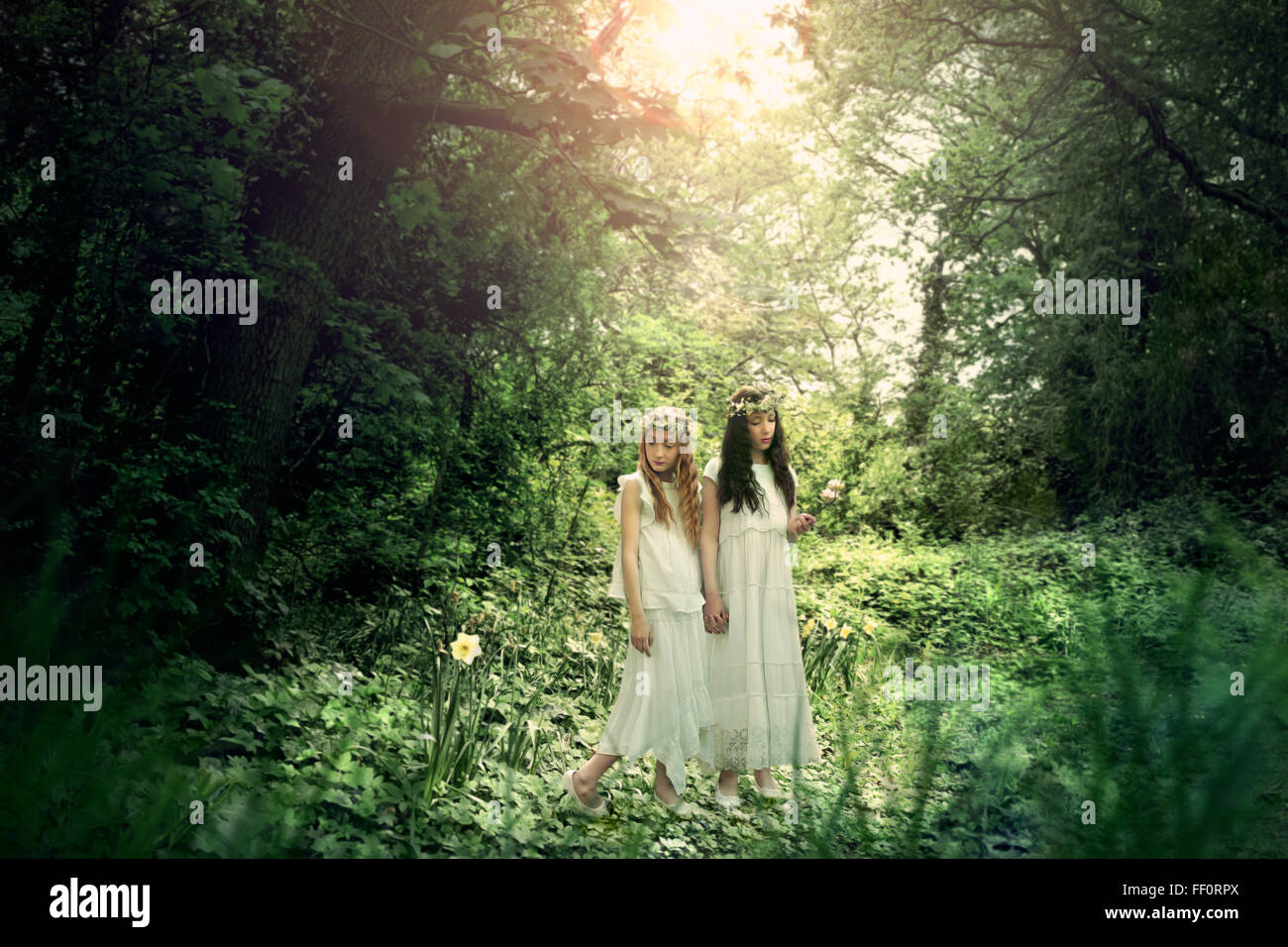 Caucasian girls exploring garden Stock Photo