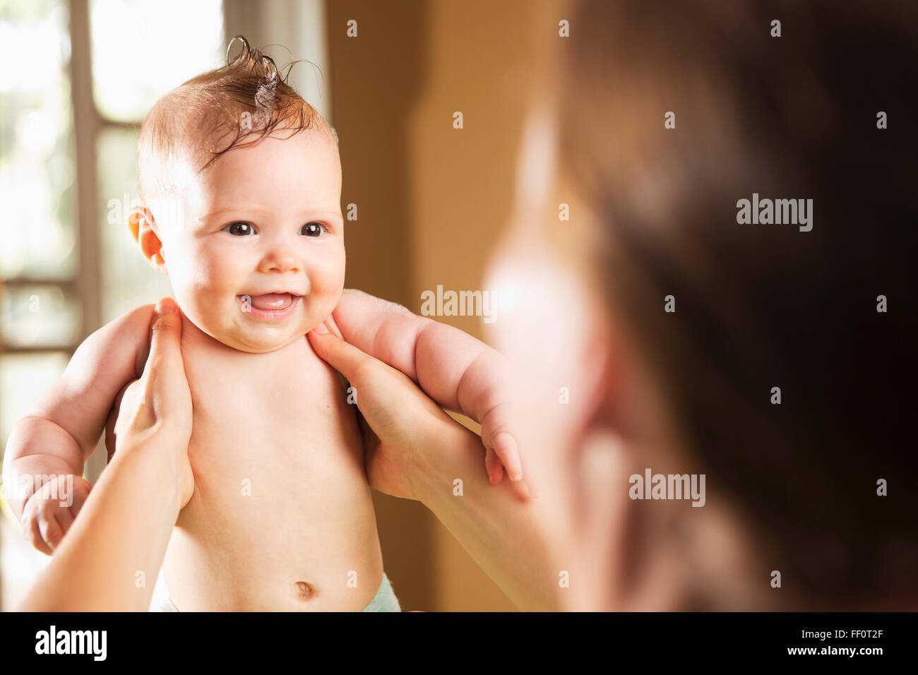Caucasian mother bathing baby daughter Stock Photo