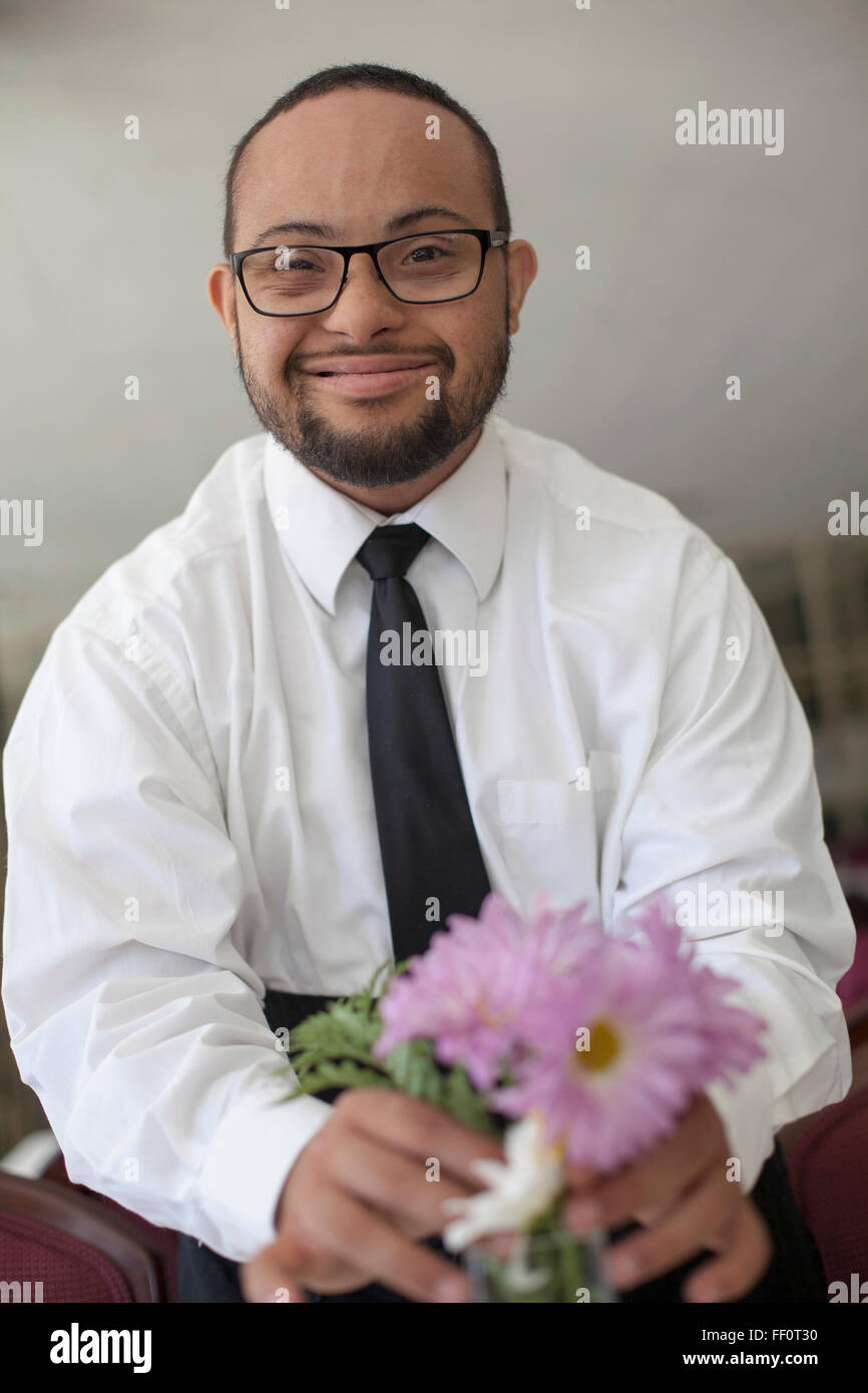 Mixed race man arranging flowers Stock Photo