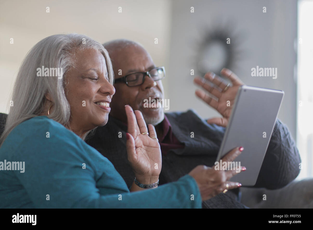 Older couple video chatting with digital tablet Stock Photo