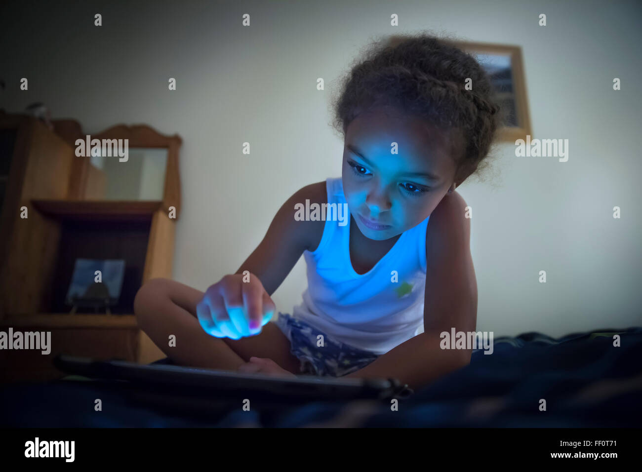 Mixed race girl using digital tablet Stock Photo