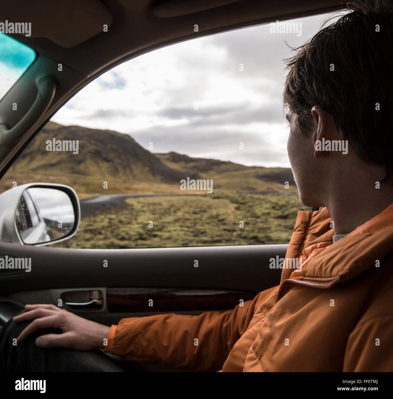 Man driving in remote landscape Stock Photo