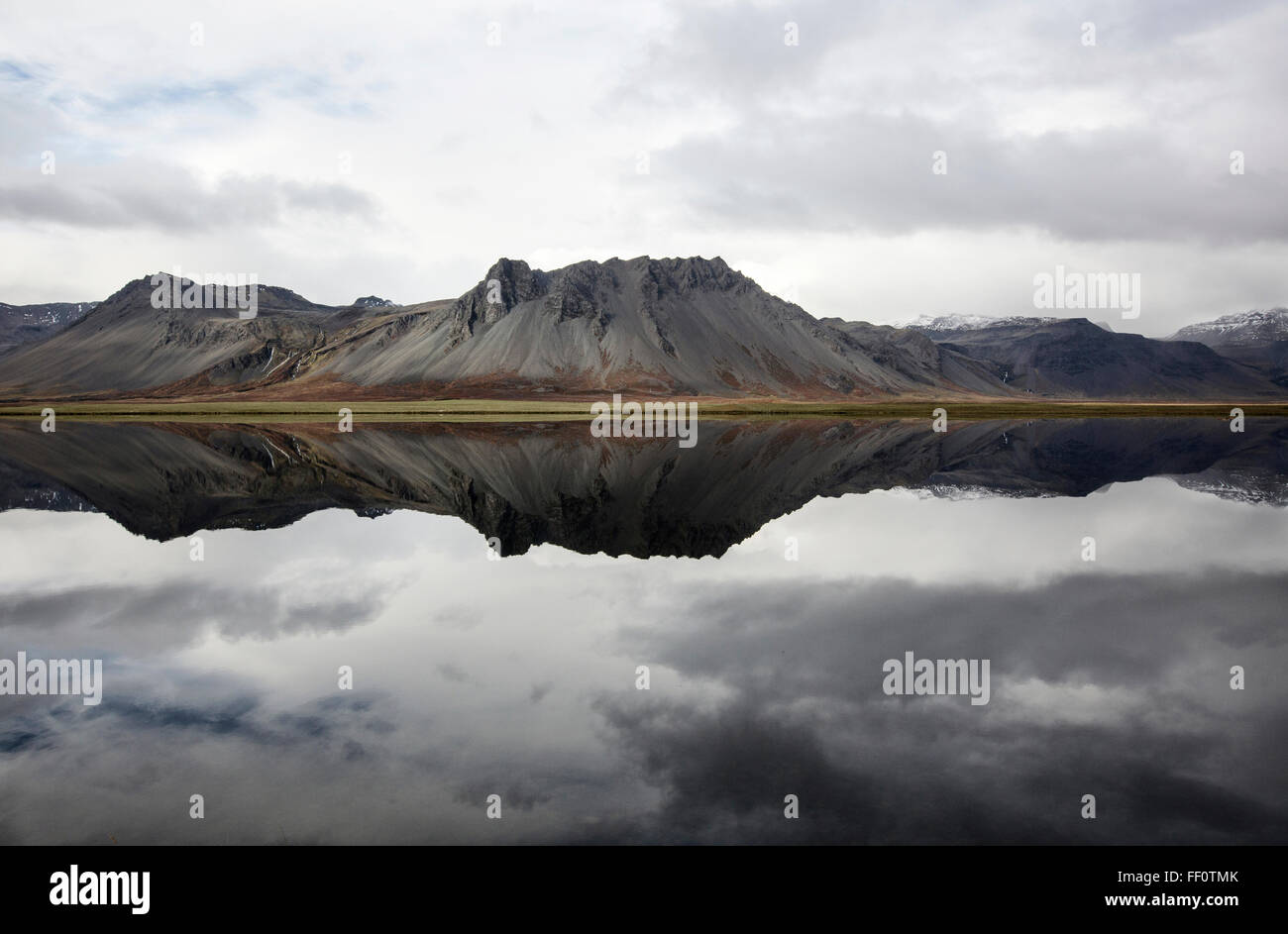 Mountains reflecting in still lake Stock Photo