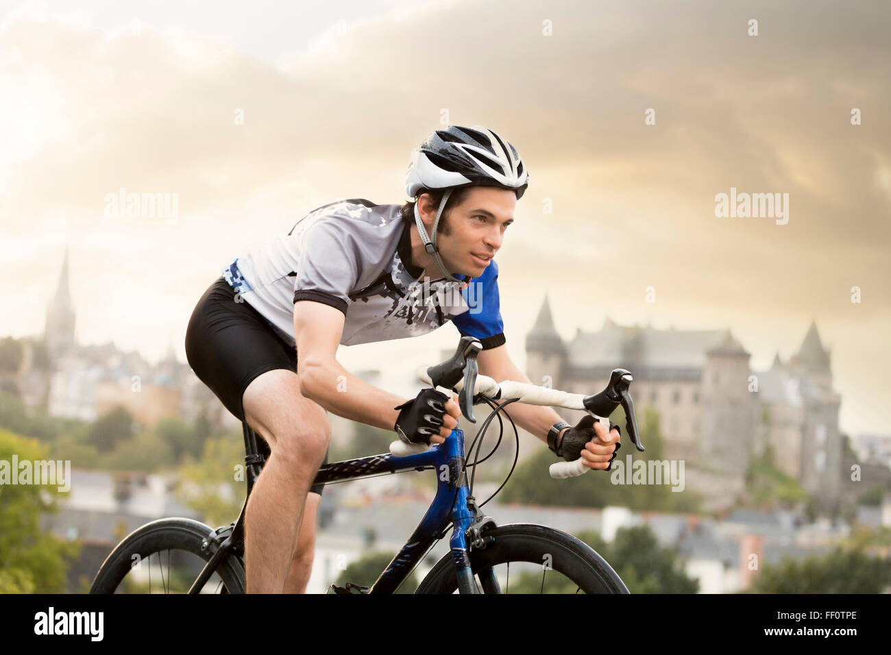 Caucasian man cycling outdoors Stock Photo