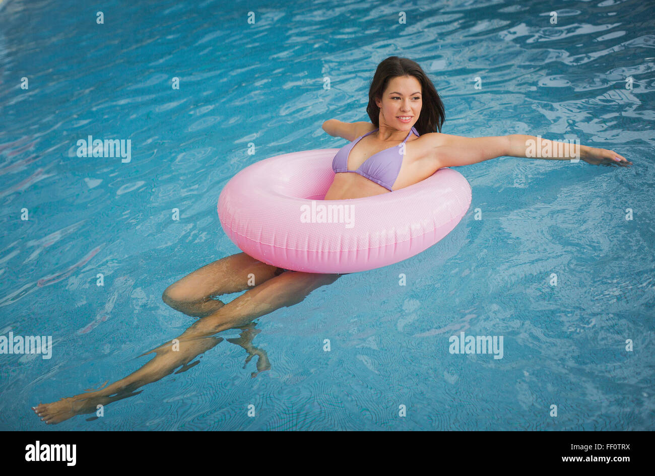 Mixed race amputee woman swimming in pool Stock Photo
