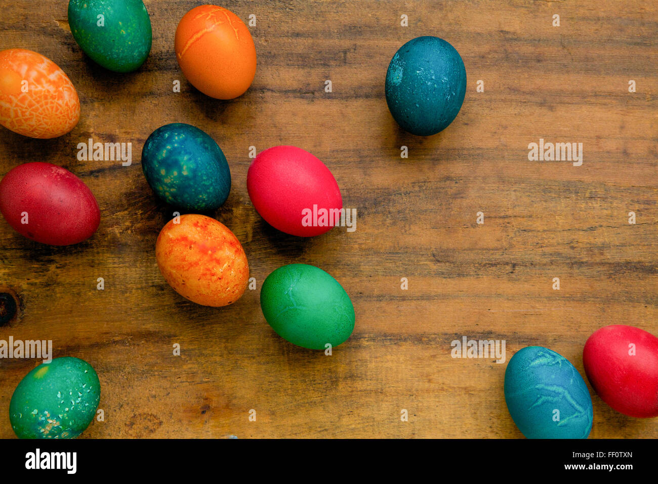 Multicolored dyed easter eggs on a wooden surface. Stock Photo