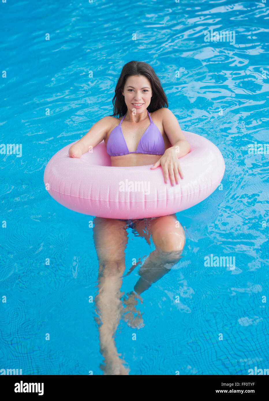 Mixed race amputee woman swimming in pool Stock Photo