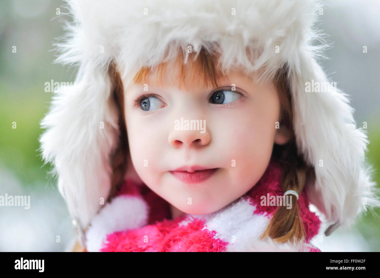 Caucasian girl wearing fuzzy hat outdoors Stock Photo
