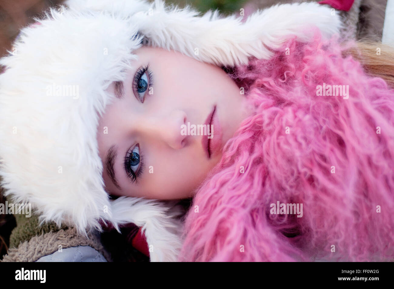 Caucasian teenage girl wearing fuzzy hat Stock Photo
