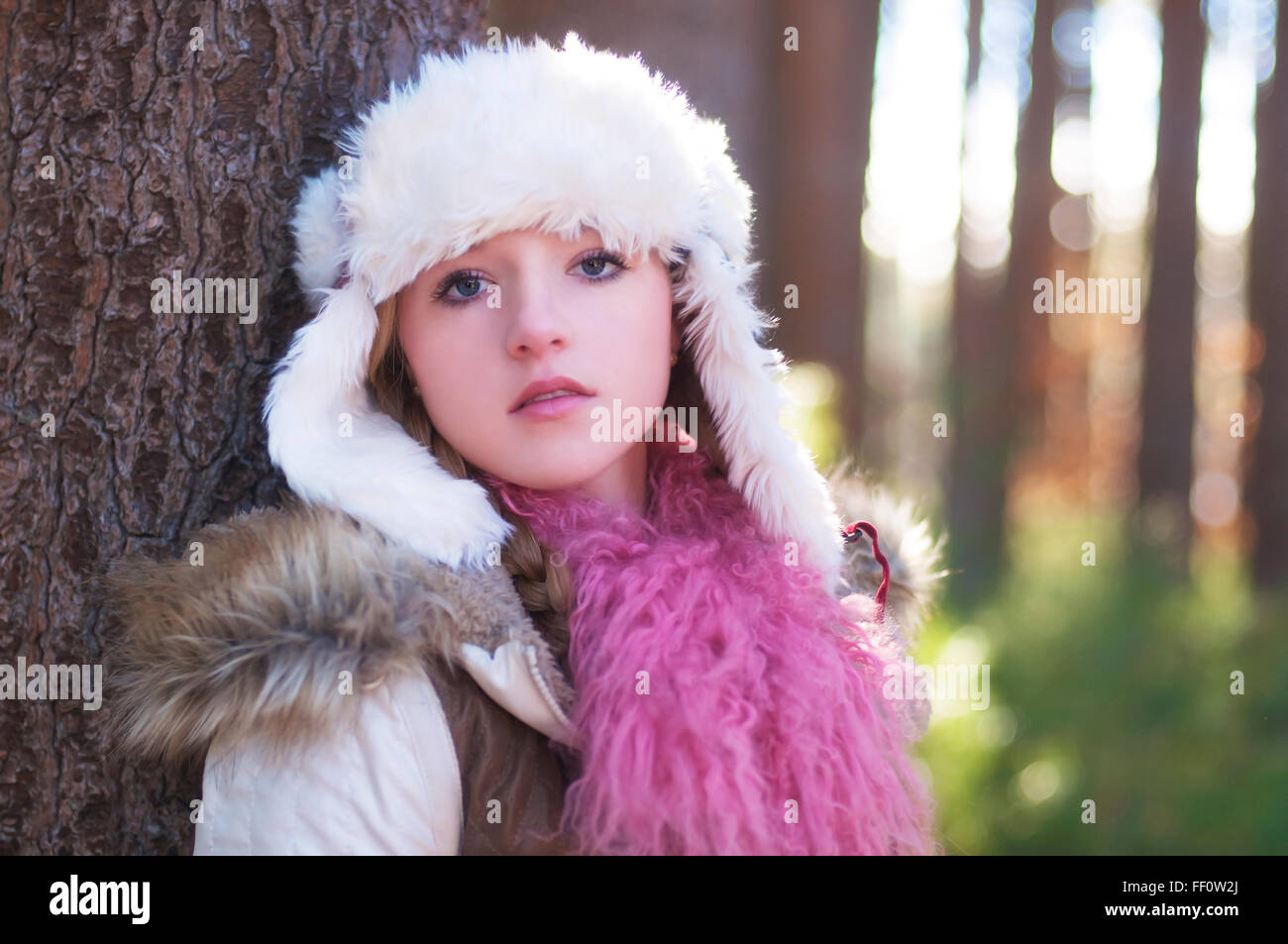 Caucasian teenage girl wearing fuzzy hat outdoors Stock Photo