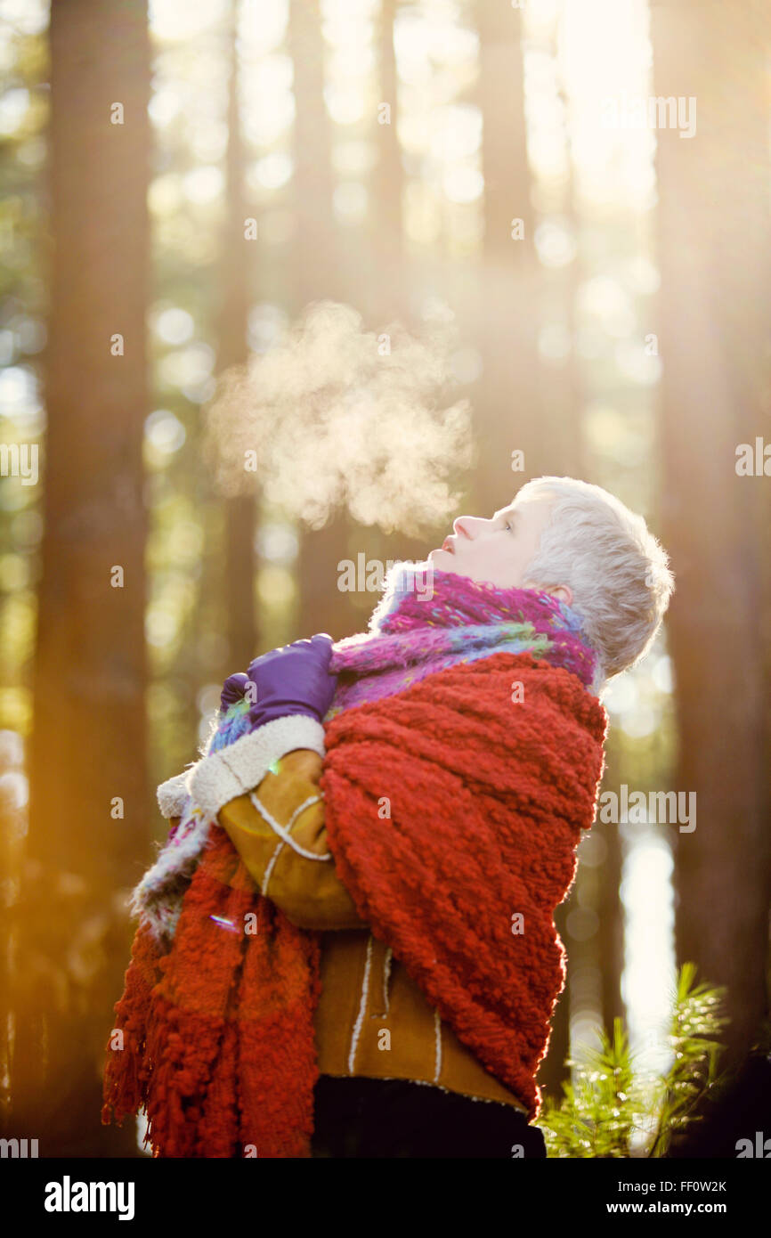 Older Caucasian woman breathing steam outdoors Stock Photo