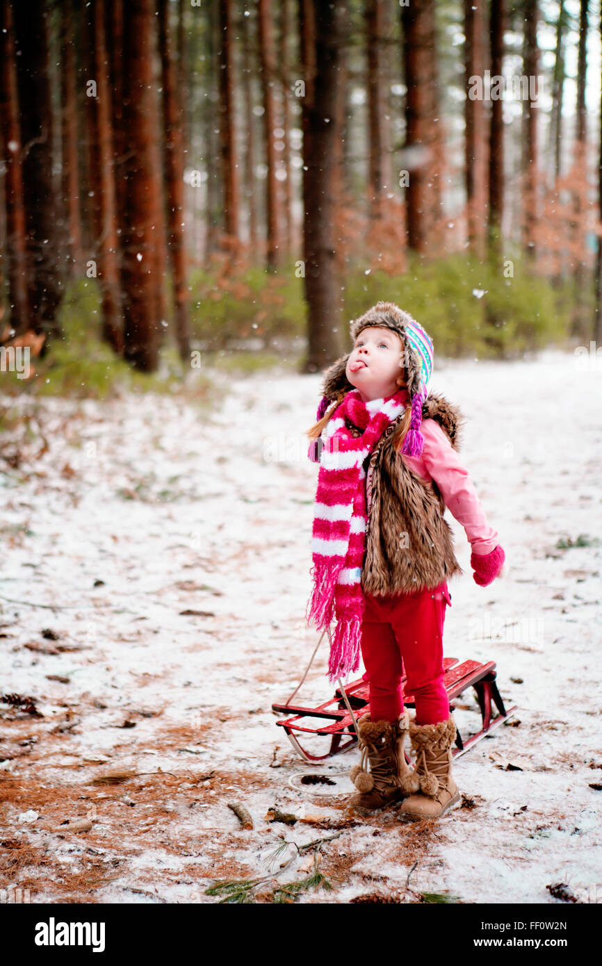 Caucasian girl catching snow on tongue Stock Photo