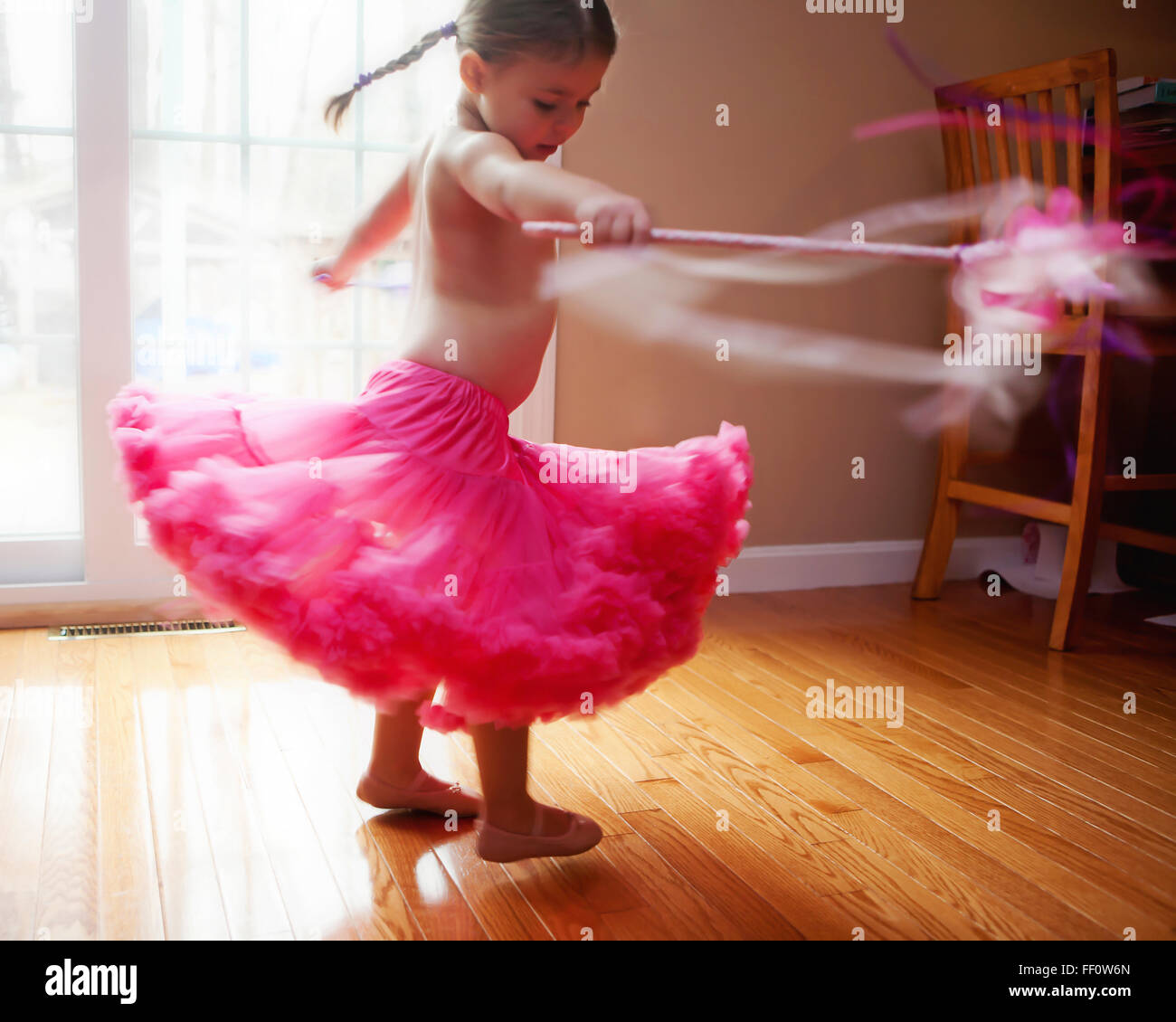 Caucasian girl twirling in skirt Stock Photo