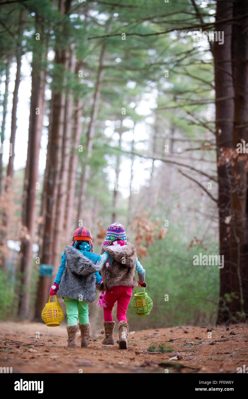 Caucasian girls walking in forest Stock Photo