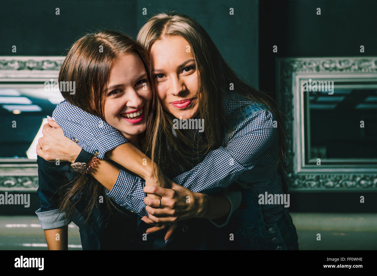 Women hugging in restaurant Stock Photo