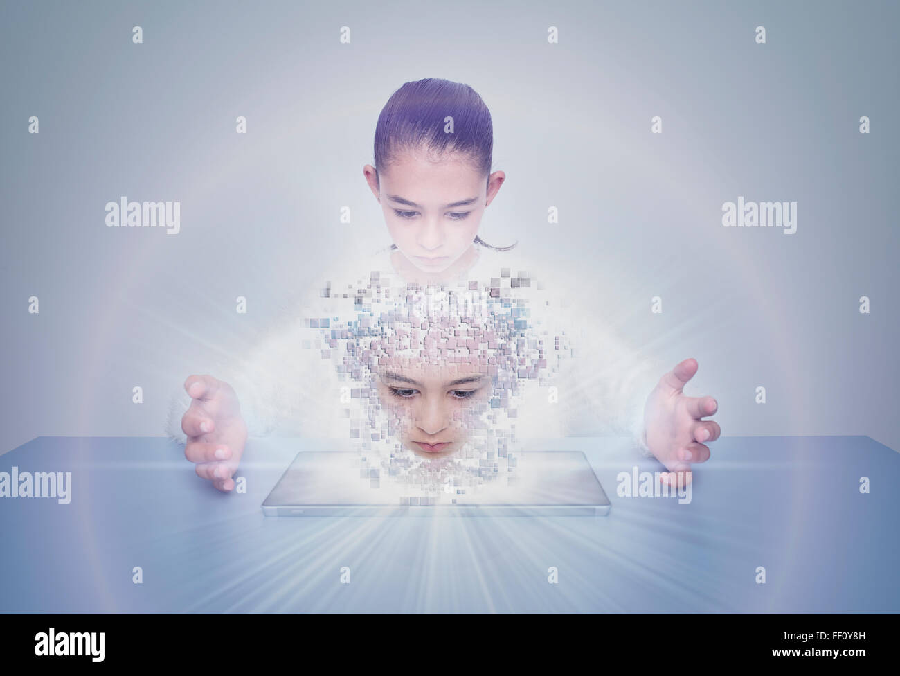 Mixed race girl with digital projection of face Stock Photo