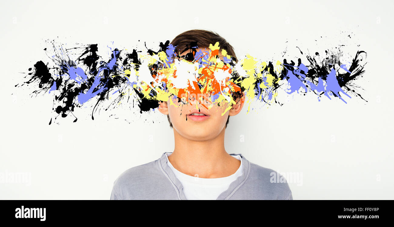 Mixed race boy with paint splatter over face Stock Photo