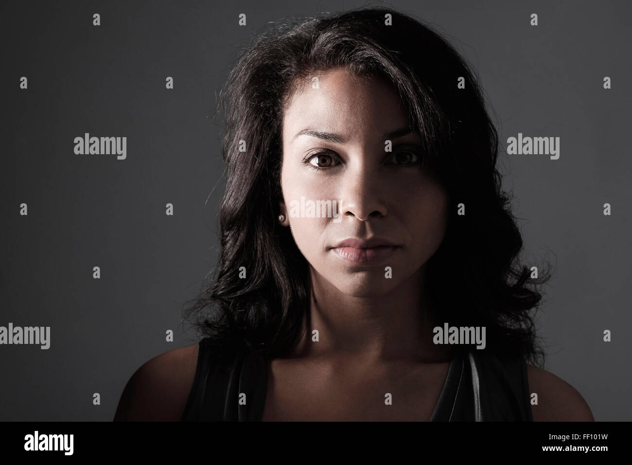Mixed race woman with serious expression Stock Photo