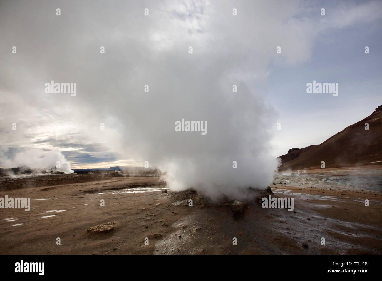 Geyser steam in remote field Stock Photo