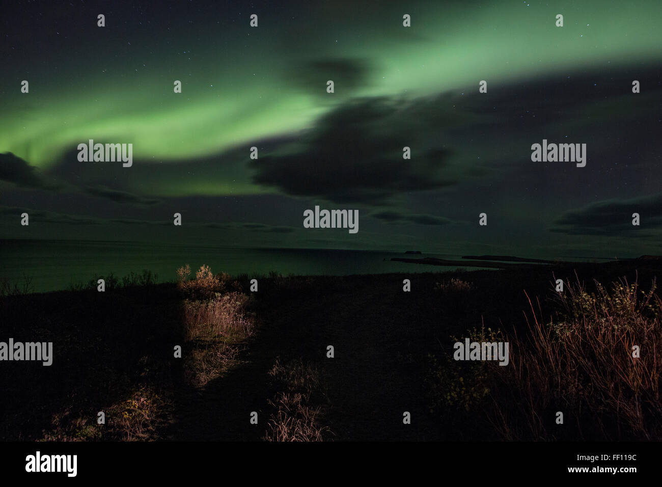 Northern lights over remote landscape Stock Photo