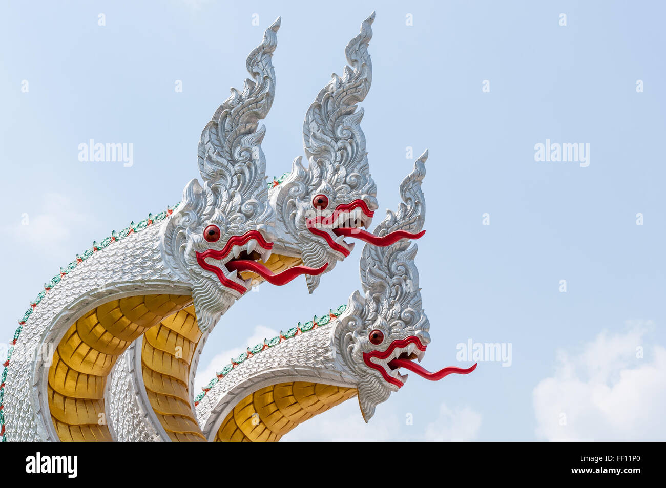 Silver dragon sculpture with three head in the traditional Thai style. Stock Photo