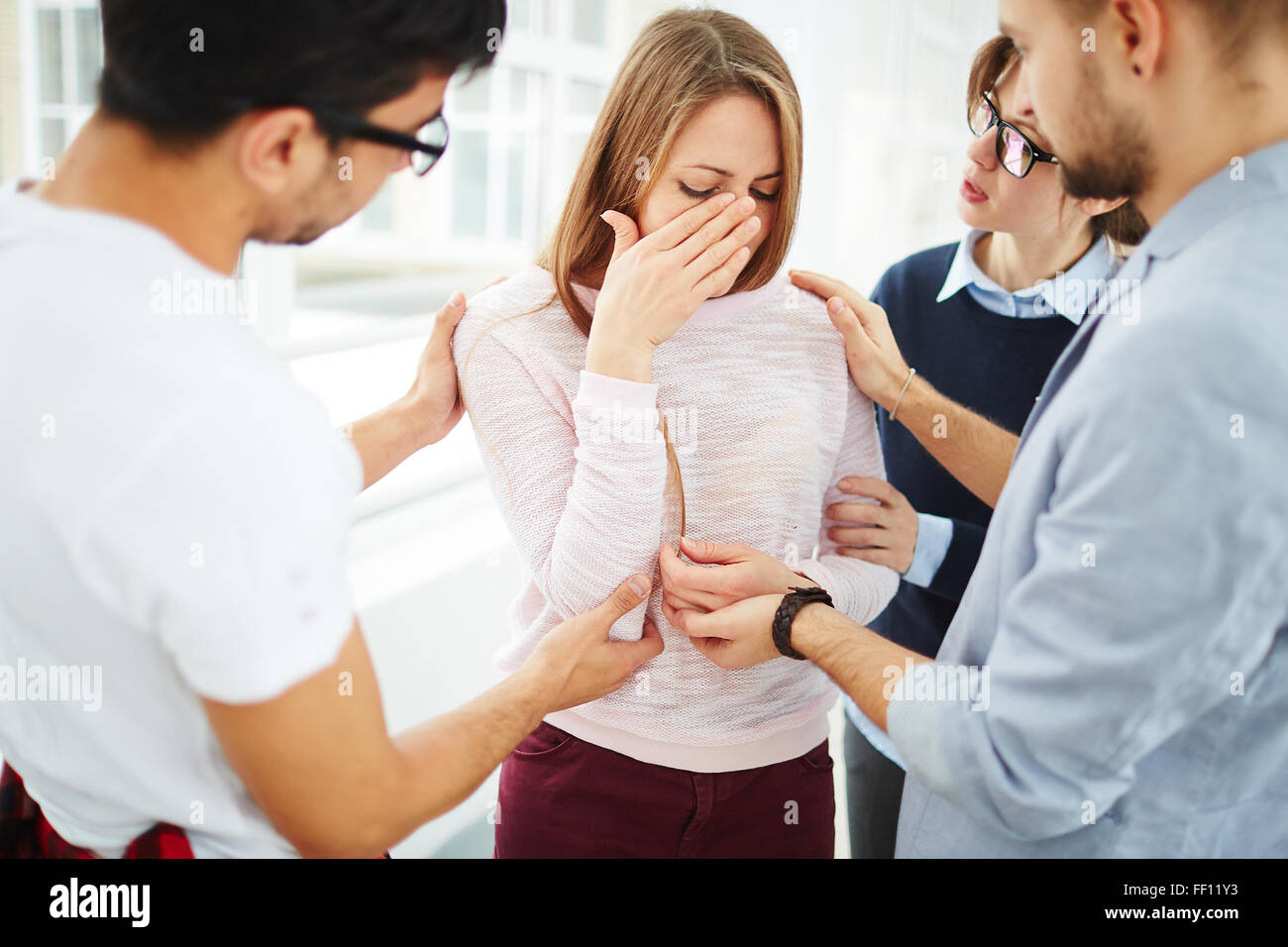 Group of students supporting their crying friend Stock Photo