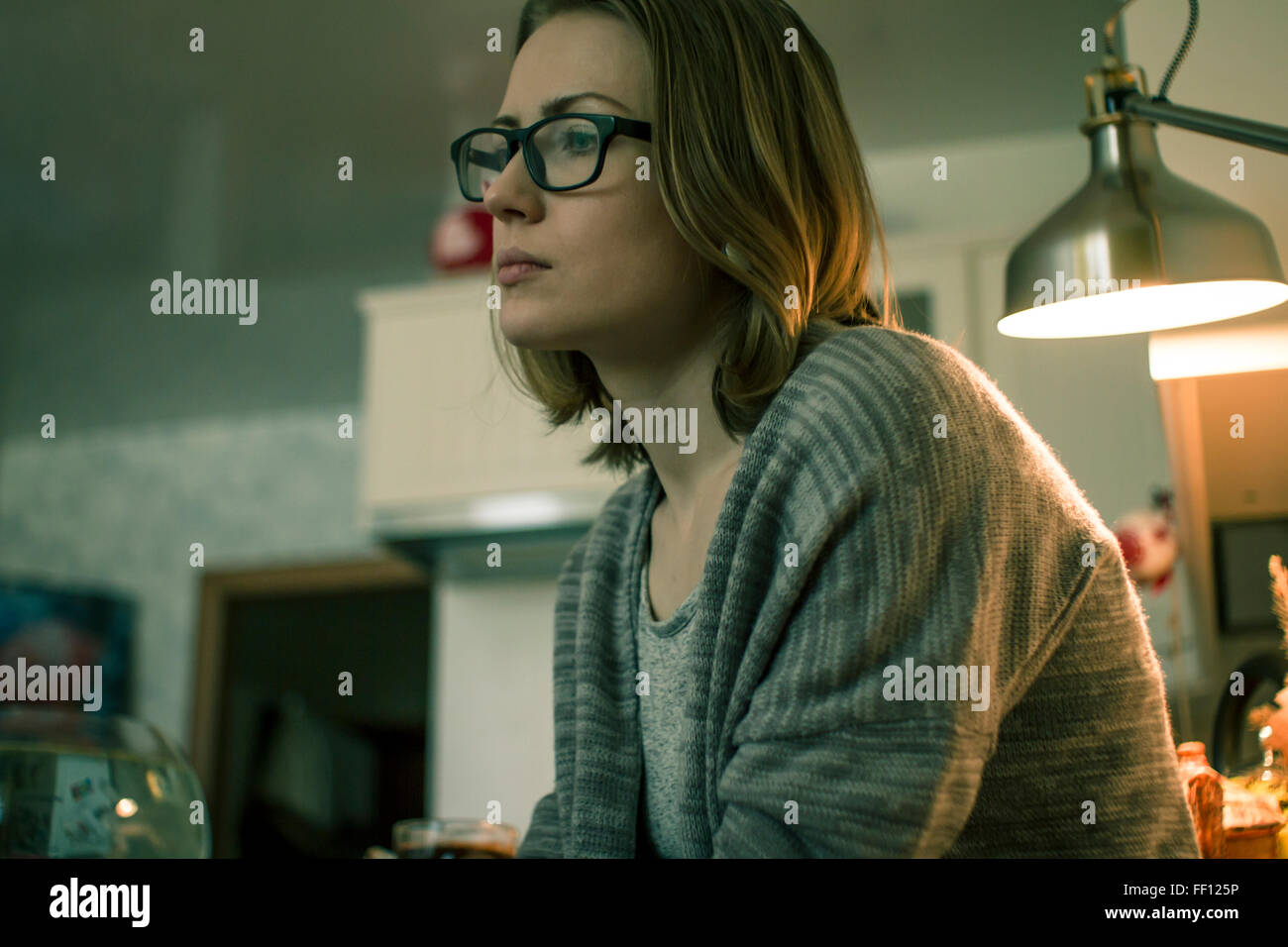 Woman glasses seated indoors hi-res stock photography and images - Alamy