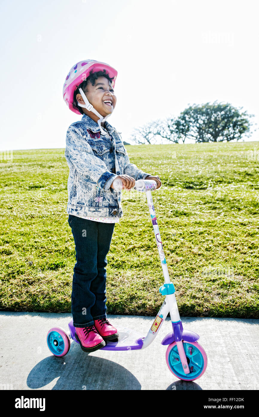 Black girl wearing helmet on scooter Stock Photo Alamy