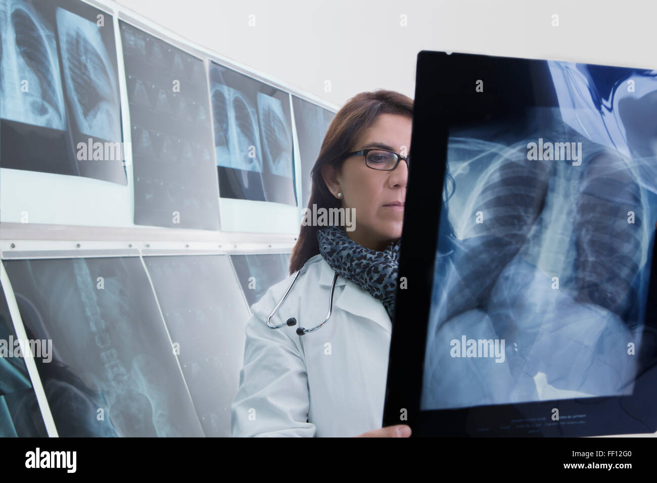 Hispanic doctor examining xrays in hospital Stock Photo Alamy