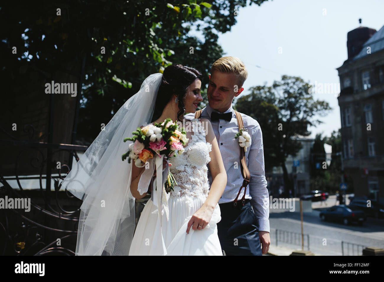 bride and groom posing on the streets of the old town Stock Photo - Alamy