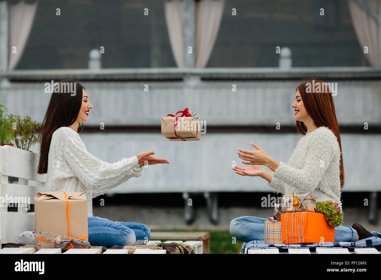 Girls throws gifts to each other Stock Photo Alamy