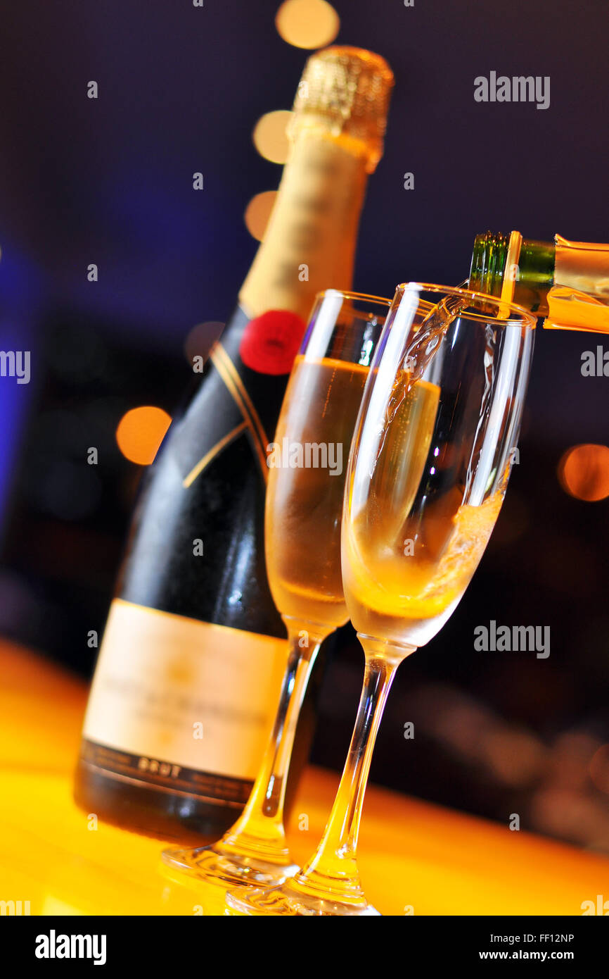 Pouring Champagne in tall glass Stock Photo