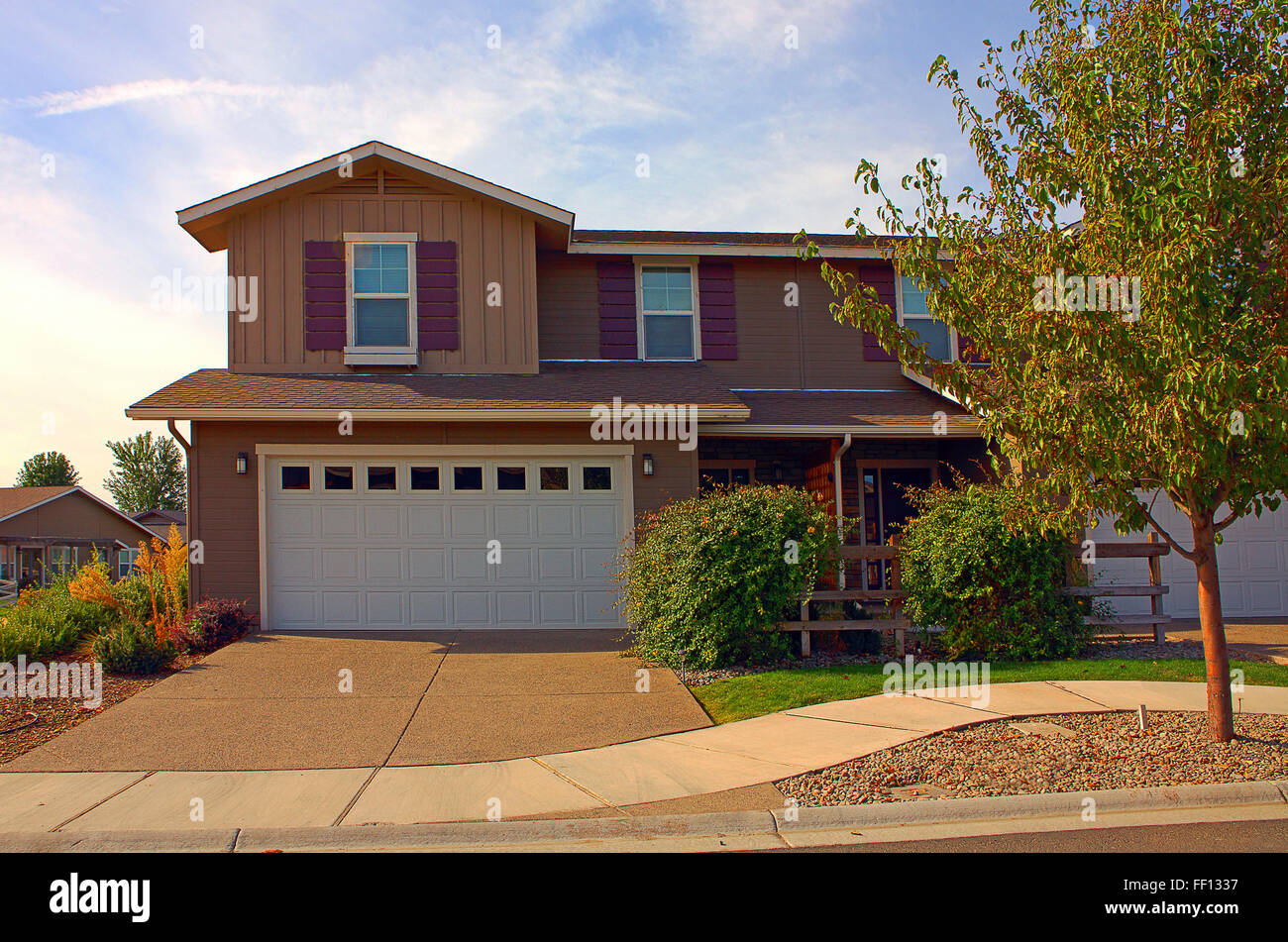 House and driveway in suburban neighborhood Stock Photo
