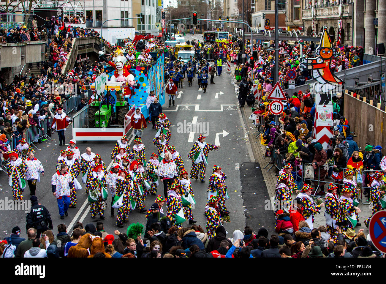 Street carnival parade and party in Cologne, Germany, at Carnival Monday, Shrove Monday, Rose Monday, people in costumes, Stock Photo