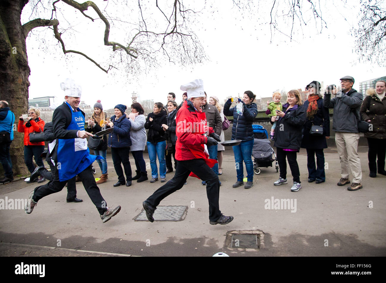 Westminster, London, United Kingdom. February 9th, 2016 -  Member of the Lords and media teams runs the Parliamentary pancake race in Victoria Tower Gardens in Westminster Credit:  Dinendra Haria/Alamy Live News Stock Photo
