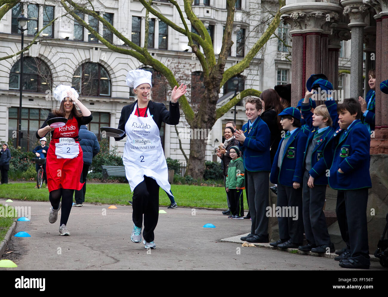 Westminster, London, United Kingdom. February 9th, 2016 - Liz Mcinnes MP and Caroline Wheeler, team captain of the media team runs at the Parliamentary pancake race in aid of the disability charity, Rehab  Credit:  Dinendra Haria/Alamy Live News Stock Photo