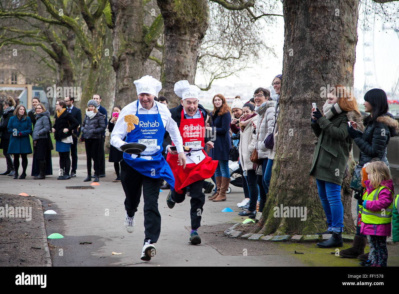 Westminster, London, United Kingdom. February 9th, 2016 - Rehab Parliamentary Pancake Race 2016 takes place as Lord Porter of Spalding CBE and Alastair Stewart OBE, ITV news presenter race against each other while tossing pancakes Credit:  Dinendra Haria/Alamy Live News Stock Photo