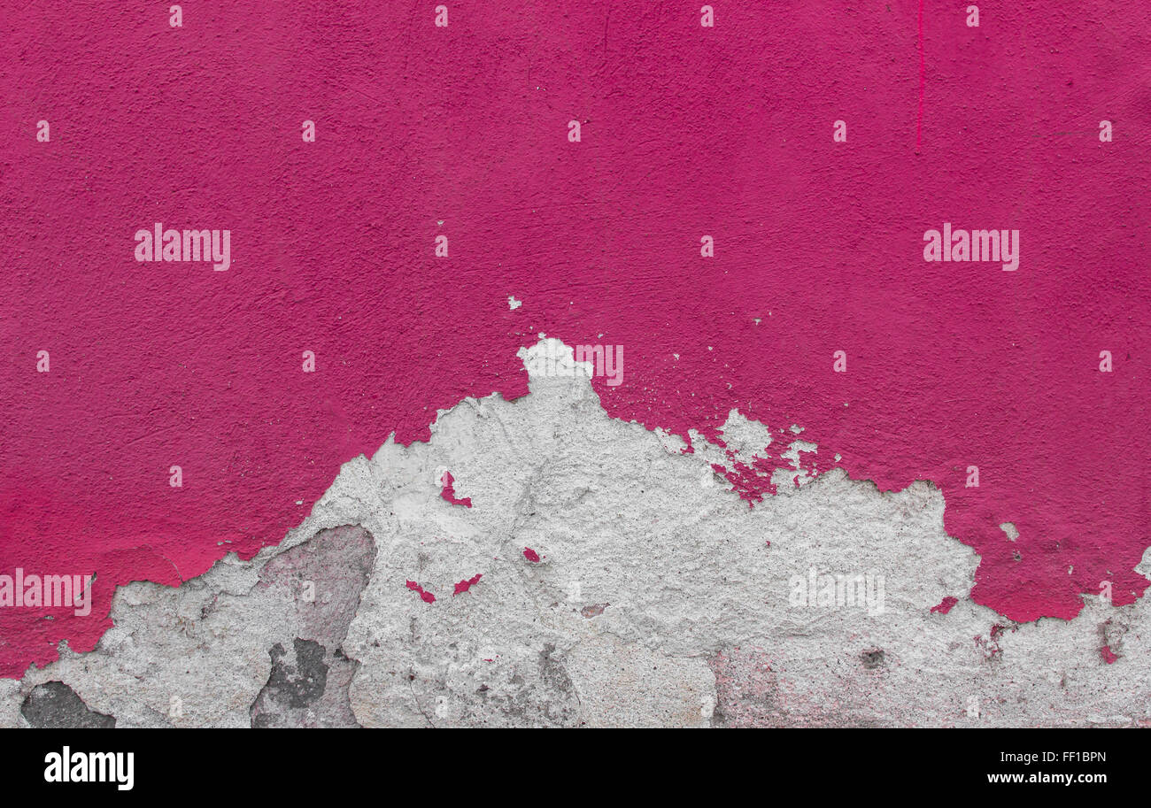 Cracked and textured pink wall, plaster background Stock Photo