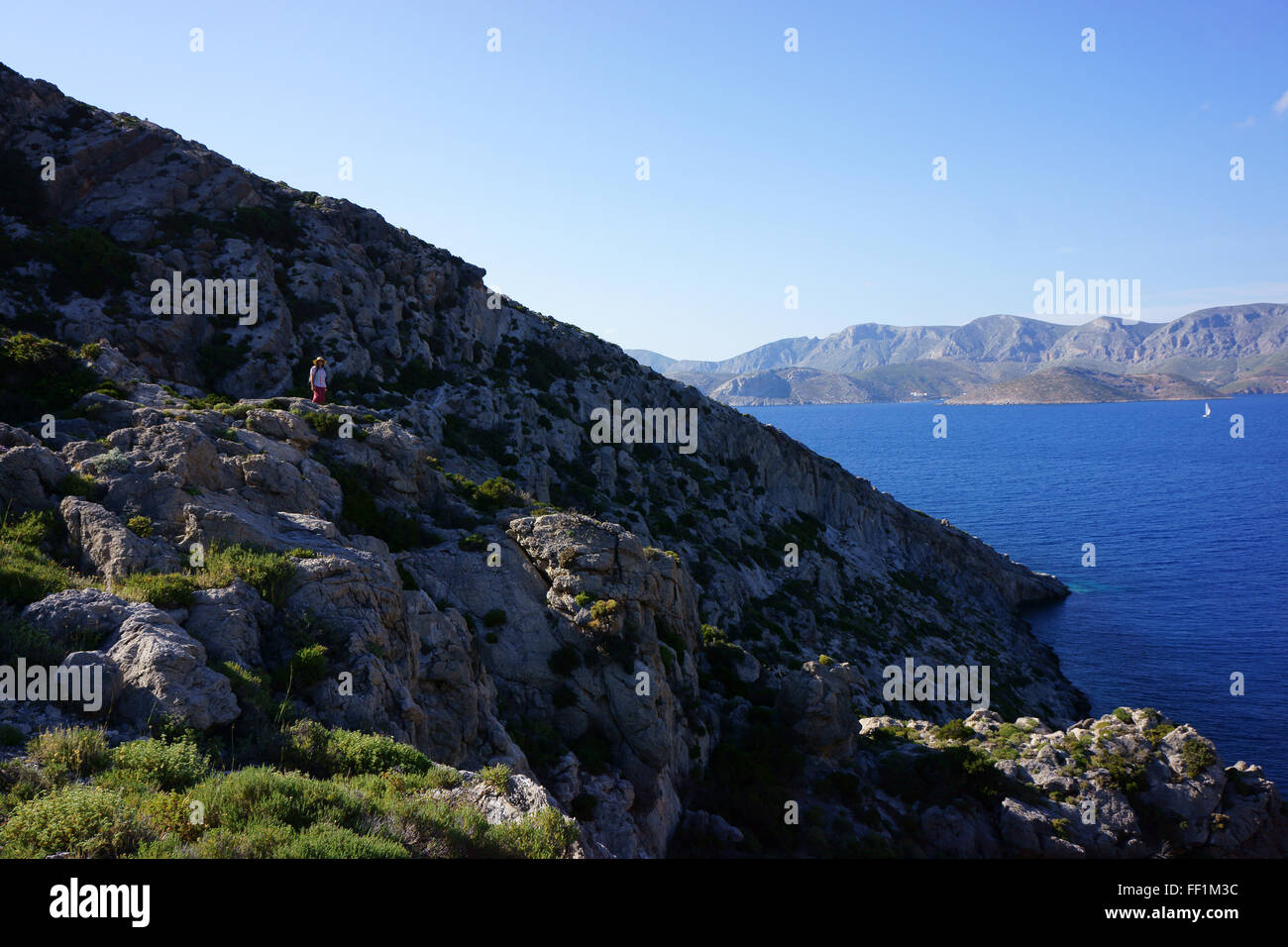 Hiking toward Agios Konstantinos, island Telendos, in back isl. Kalymnos, Dodekanes, Greece Stock Photo