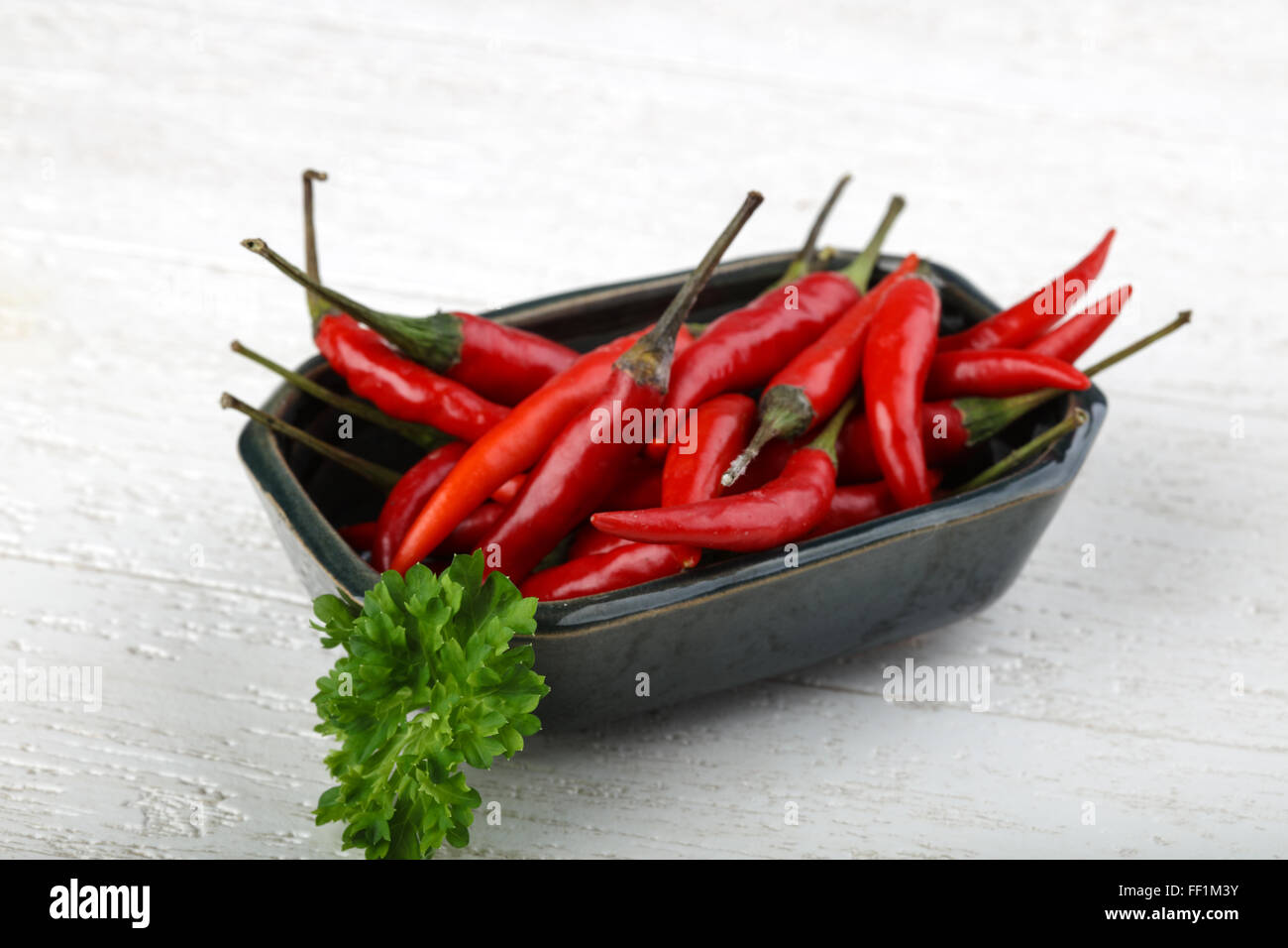 Red hot chili peppers heap on the wood background Stock Photo - Alamy